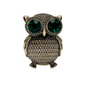 Owl brooch with textured gold-tone metal finish and large green faceted stone eyes, cutout on white background.