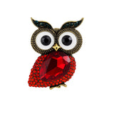 Owl brooch with red faceted stone body, white eyes with black centers, and green accent stones on ears, cutout on white background.