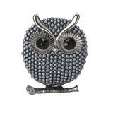 Owl brooch with silver-tone finish, dark grey round beads, black eyes, and branch detail, cutout on white background.