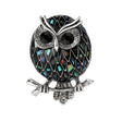 Owl brooch with multicolor mosaic-style pattern on black base, silver-tone outline, and black faceted eyes, cutout on white.