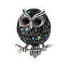 Owl brooch with multicolor mosaic-style pattern on black base, silver-tone outline, and black faceted eyes, cutout on white.