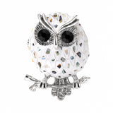 Owl brooch with multicolor mosaic-style pattern on white base, silver-tone outline, and black faceted eyes, cutout on white.
