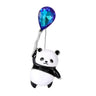 Panda brooch with glossy black and white enamel and large blue and purple teardrop-shaped faceted stone, cutout on white background.