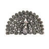 Peacock brooch with black faceted stones and silver-tone base, teardrop center stone, cutout on white.