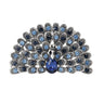 Peacock brooch with light and dark blue faceted stones, silver-tone metal, and blue teardrop center stone, cutout on white.