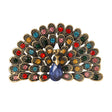 Peacock brooch with multicolor faceted stones, gold-tone base, and blue teardrop center stone, cutout on white.