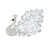 Peacock brooch with silver-tone base, clear teardrop stones, and round clear accents on body and crest, cutout on white.