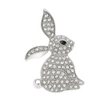 Bunny brooch in silver-tone metal with clear faceted stones and black eye detail, cutout on white background.