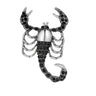 Scorpion brooch with silver-tone finish, black faceted stones, and segmented tail, isolated on white background.