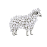 Sheep brooch with silver-tone metal, white round beads, and clear accent stones on ear, cutout on white background.
