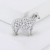 Sheep brooch in silver-tone metal with layered white round beads and crystal ear detailing, upright view on white studio background.
