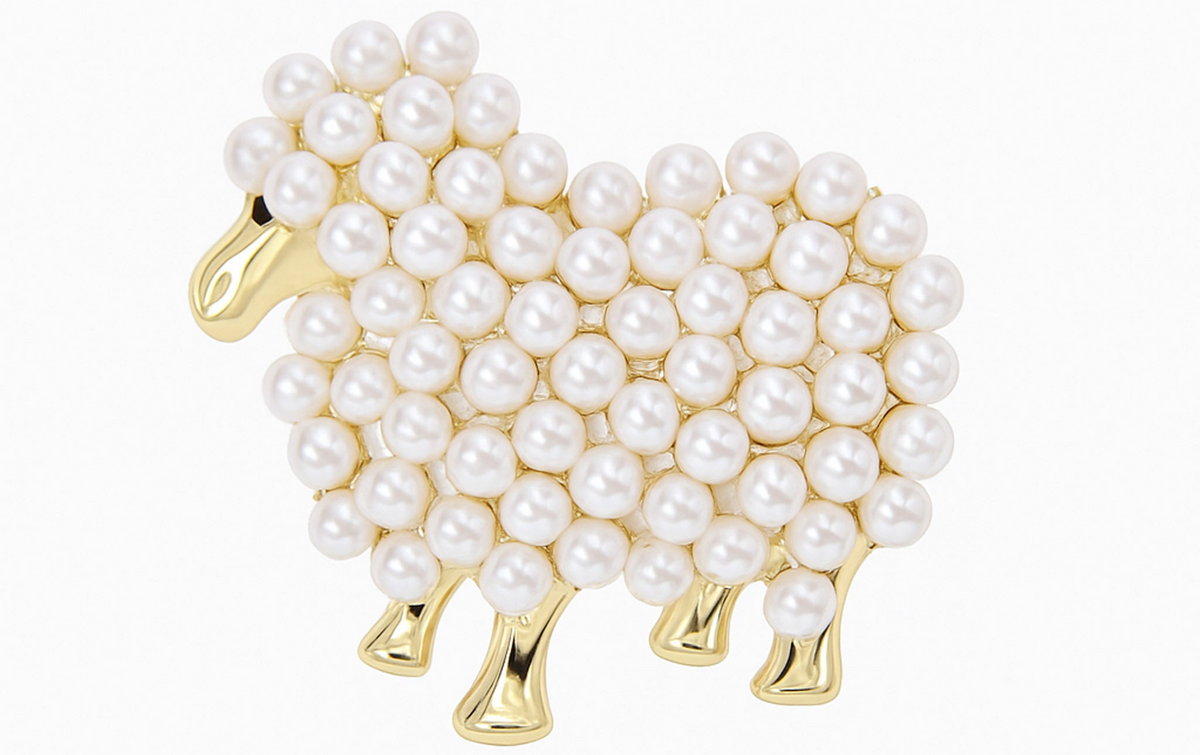 Sheep brooch with gold-tone metal and white round beads clustered in a textured pattern, cutout on white. Landscape crop for secondary use.