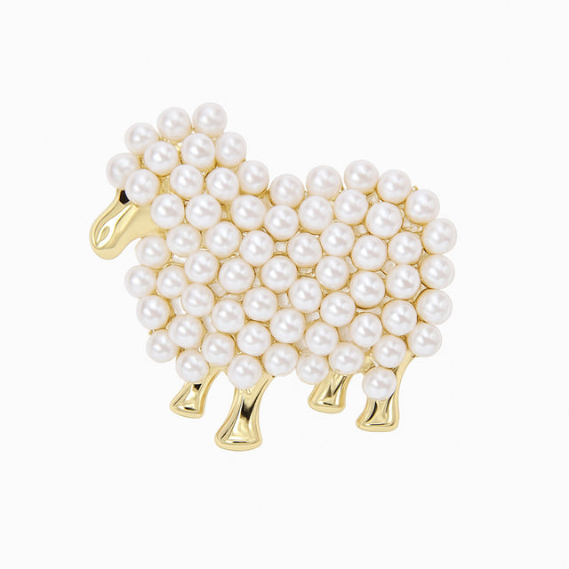 Sheep brooch with gold-tone metal and white round beads clustered in a textured pattern, cutout on white.