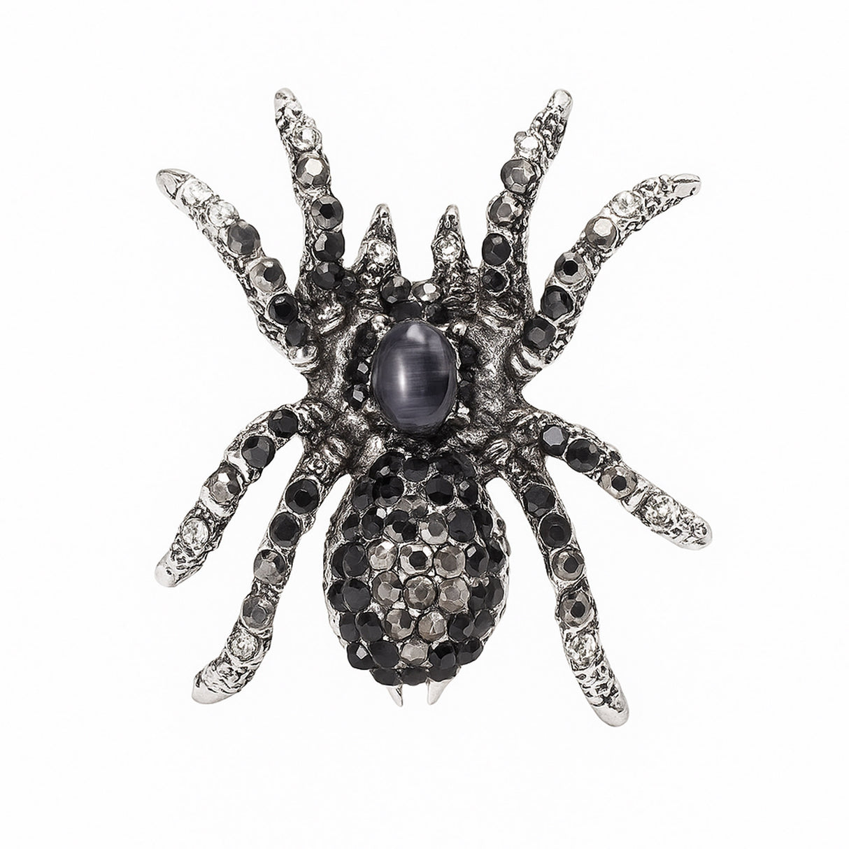Tarantula brooch with silver-tone base, black and clear faceted stones, and a dark oval cabochon center, cutout on white.