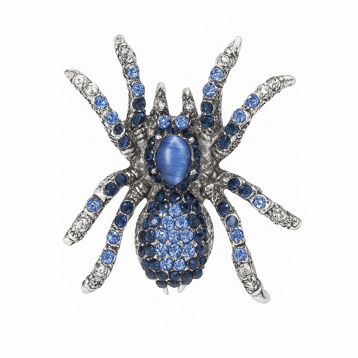 Tarantula brooch with silver-tone base, light and dark blue faceted stones, and a blue oval cabochon center, cutout on white.