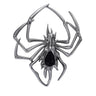 Spider brooch with dark silver-tone metal and black teardrop-shaped faceted center stone, cutout on white background.