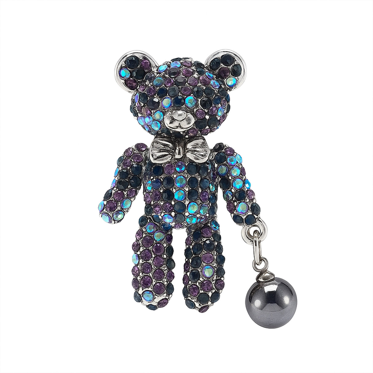 Teddy bear brooch with purple and blue iridescent stones, silver-tone bow, and dark metallic hanging faux pearl, cutout on white.