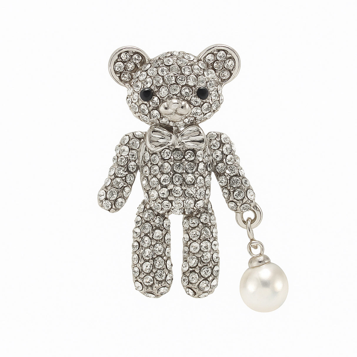Teddy bear brooch with clear stones, silver-tone metal base and bow, and white round hanging bead, cutout on white background.
