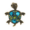 Turtle brooch with vintage-style gold-tone dotted metal finish, blue and green round faceted stones in various sizes, cutout on white.